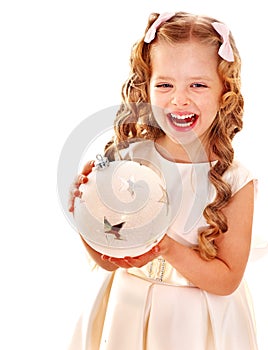 Child holding big white Christmas ball.