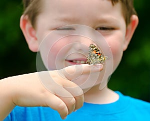 Child holding a butterfly photo