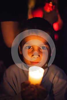 Child holding candle