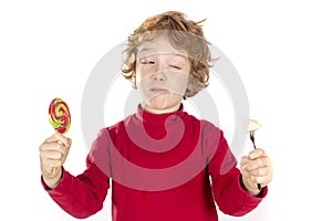 Child holding candy and fruit