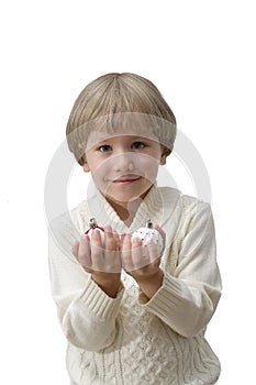 Child holding Christmas decoration in hand. Boy Isolated on white background. New year and x-mas concept.