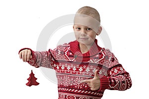 Child holding Christmas gift box in hand. Boy Isolated on white background. New year and x-mas concept.