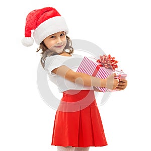 Child holding Christmas gift box in hand. Isolated
