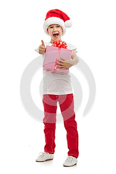 Child holding Christmas gift box in hand. Isolated