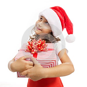 Child holding Christmas gift box in hand. Isolated