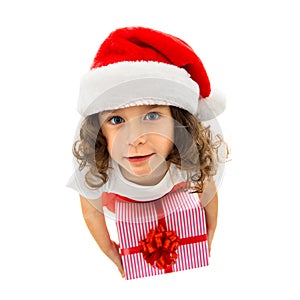 Child holding Christmas gift box in hand. Isolated on white