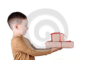 Child holding Christmas gift box in hand. Isolated on white background