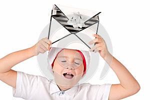 Child holding Christmas gift box in his hand the boy laughs with his eyes closed . Isolated on white background