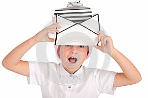 Child holding Christmas gift box on his head say something . Isolated on white background