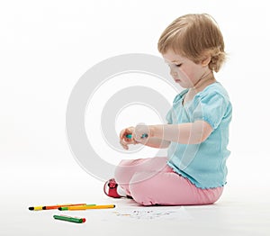 Child holding colorful felt-tip pens