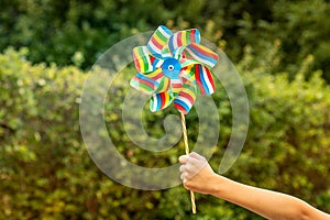 Child holding colorful pinwheel