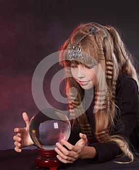 Child holding crystal ball.