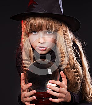 Child holding crystal ball.