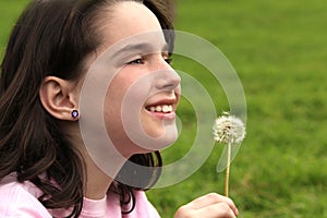 Child Holding Dandilion Looking Up