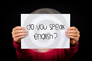 Child holding Do You Speak English sign