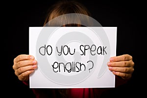 Child holding Do You Speak English sign