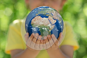 Child holding Earth planet in hands