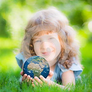 Child holding Earth planet in hands