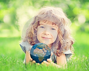 Child holding Earth planet in hands