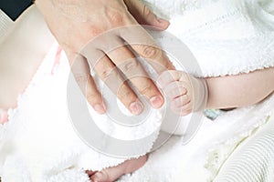 Child holding father's hand