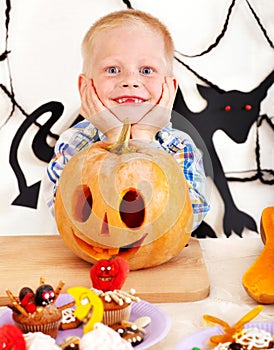 Child holding Halloween pumpkin carving .