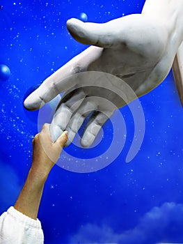 Child Holding Hand of Jesus Statue