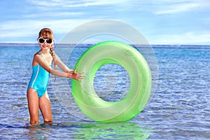 Child holding inflatable ring..