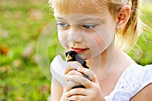 Child holding a little chick