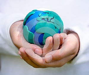 Child holding model of Earth