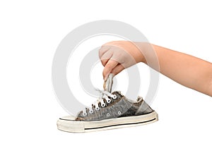 Child Holding An Old Dirty and Smelly Sneaker