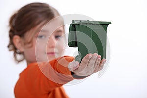 Child holding recycling bin