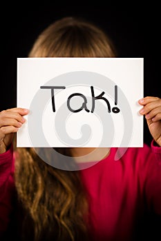 Child holding sign with Danish word Tak - Thank You photo