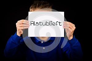 Child holding sign with Dutch word Alstublieft - Please