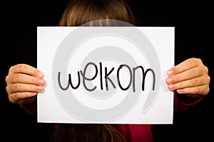 Child holding sign with Dutch word Welkom - Welcome photo