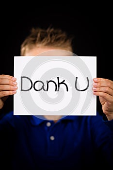 Child holding sign with Dutch words Dank U - Thank You photo
