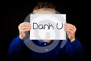 Child holding sign with Dutch words Dank U - Thank You photo