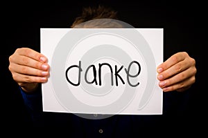 Child holding sign with German word Danke - Thank You