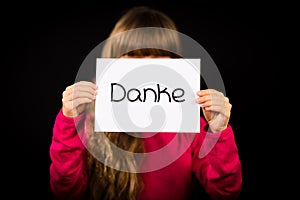 Child holding sign with German word Danke - Thank You