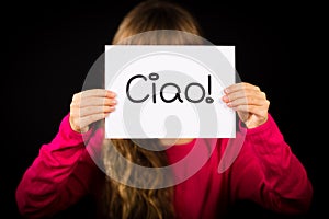 Child holding sign with Italian word Ciao - Hello