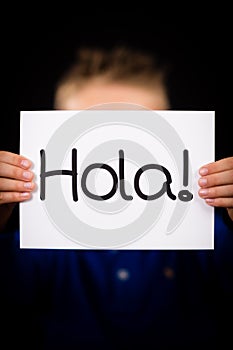 Child holding sign with Spanish word Hola - Hello photo