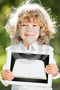 Child holding tablet PC with ebook