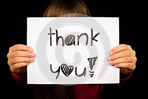 Child holding Thank You sign