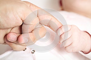 Child holding on to father's hand