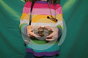 child holding a turtle. A young girl wants to become an exotic veterinarian