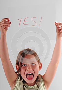 Child holding YES sign