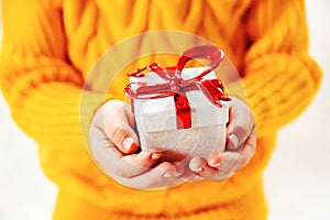 Child holds a Christmas decor and gifts on a white background. Selective focus.