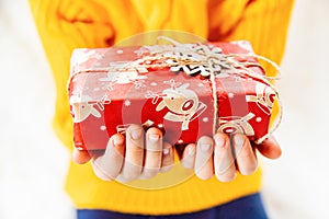 Child holds a Christmas decor and gifts on a white background. Selective focus.