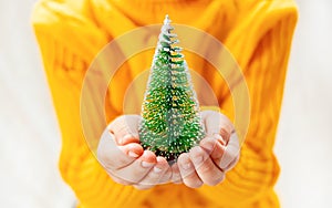 Child holds a Christmas decor and gifts on a white background. Selective focus.