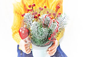 Child holds a Christmas decor and gifts on a white background. Selective focus