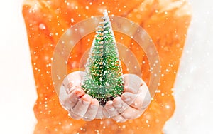 Child holds a Christmas decor and gifts on a white background. Selective focus